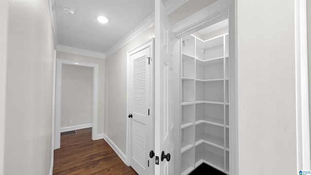 hall featuring ornamental molding and dark hardwood / wood-style flooring