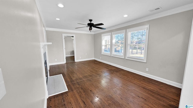 unfurnished living room with dark wood-type flooring, ornamental molding, and ceiling fan