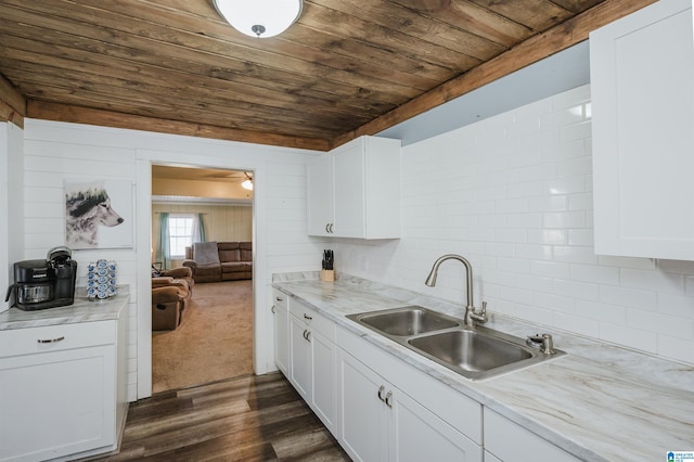 kitchen featuring tasteful backsplash, sink, white cabinets, dark hardwood / wood-style flooring, and wooden ceiling