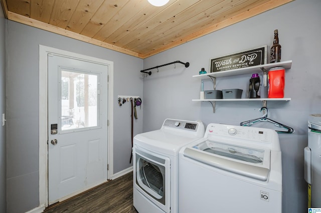 clothes washing area with washer and dryer, wooden ceiling, and dark hardwood / wood-style floors