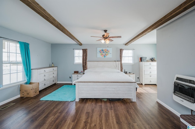 bedroom with ceiling fan, dark hardwood / wood-style flooring, beam ceiling, and heating unit