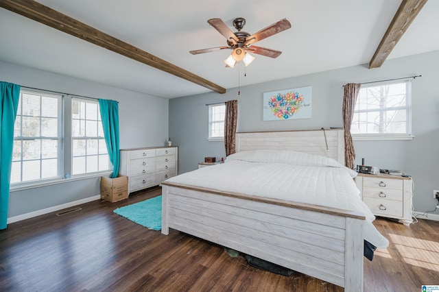 bedroom with ceiling fan, dark hardwood / wood-style flooring, and beam ceiling