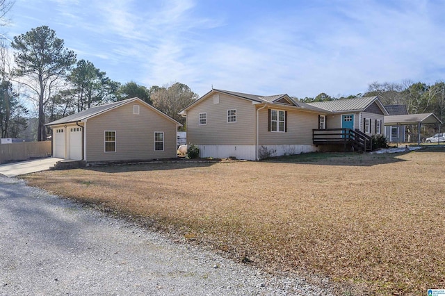 exterior space with a carport, a garage, and a yard