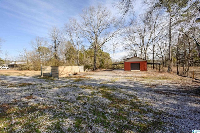 view of yard featuring a garage and an outdoor structure