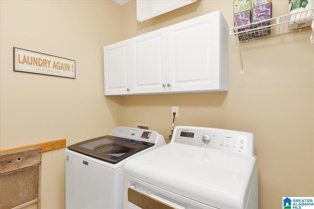 washroom featuring cabinets and washing machine and clothes dryer