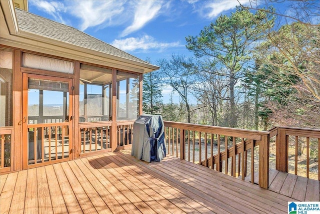 wooden deck with a sunroom