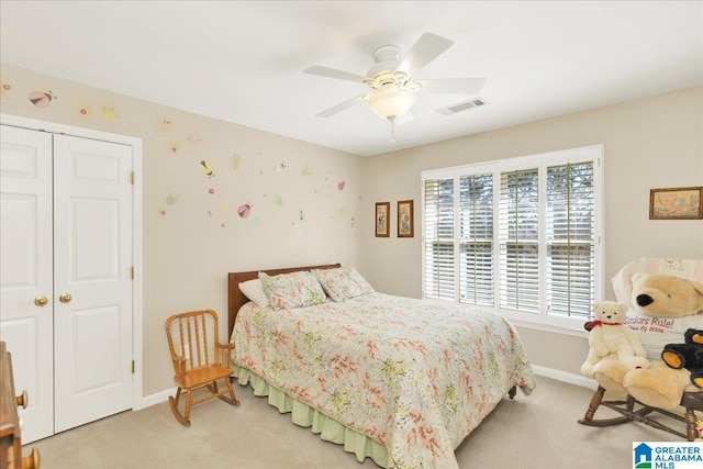 carpeted bedroom with ceiling fan and a closet