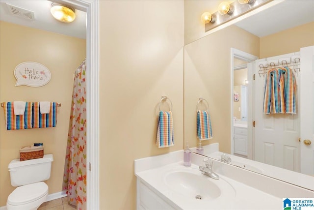 bathroom featuring vanity, a shower with shower curtain, tile patterned floors, and toilet