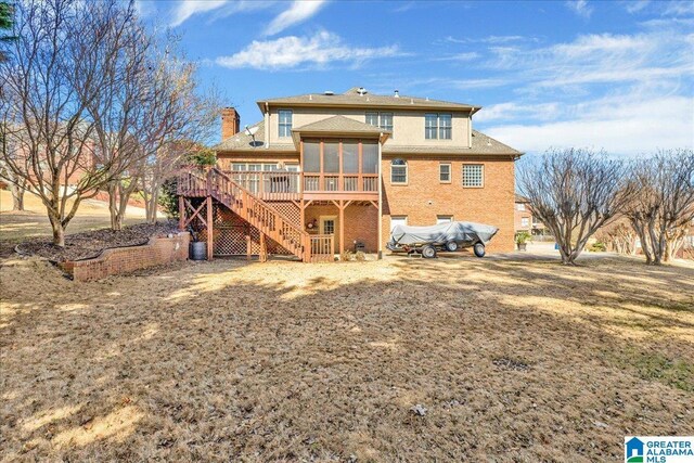 back of house featuring a sunroom and a deck