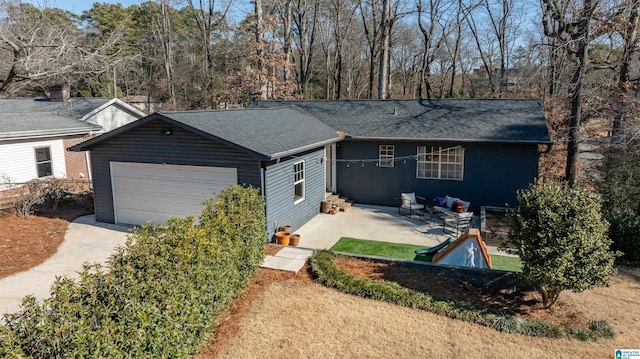 ranch-style house with a garage and a patio area