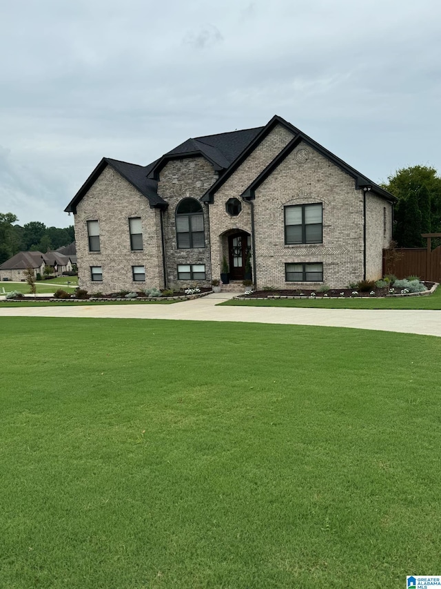 french country style house featuring a front yard