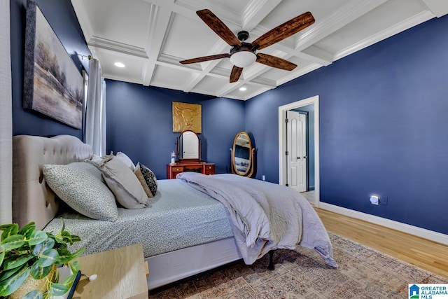 bedroom featuring crown molding, ceiling fan, coffered ceiling, wood-type flooring, and beamed ceiling