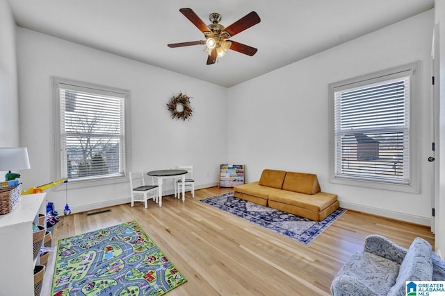 playroom with hardwood / wood-style floors and ceiling fan