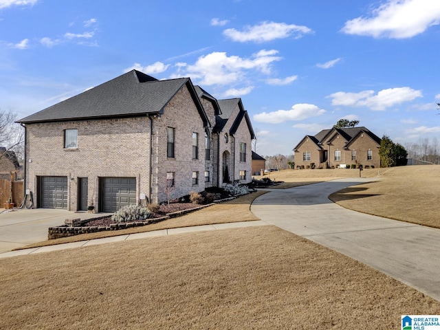 view of side of home featuring a garage and a lawn