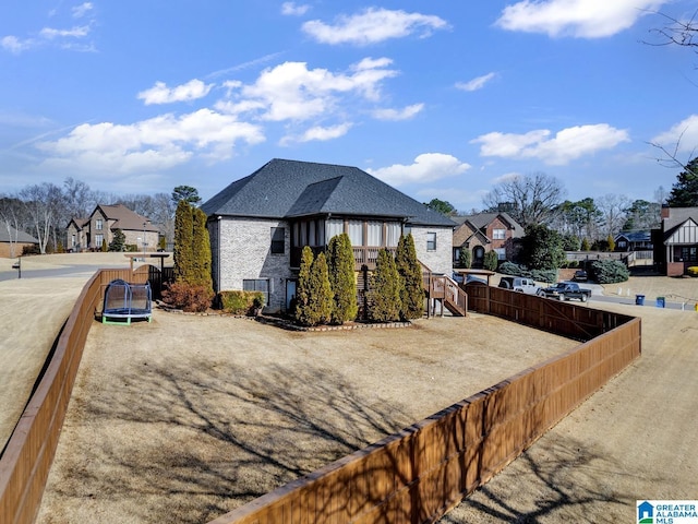 view of side of home featuring a trampoline