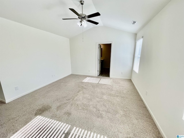 unfurnished room featuring ceiling fan, lofted ceiling, and light carpet