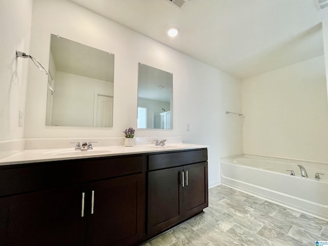 bathroom with a tub to relax in and vanity