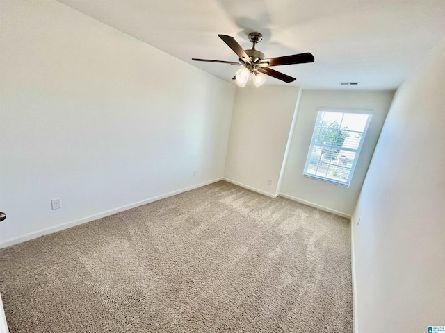 empty room featuring carpet floors and ceiling fan