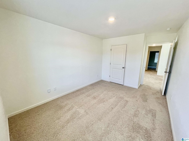 unfurnished bedroom featuring light colored carpet