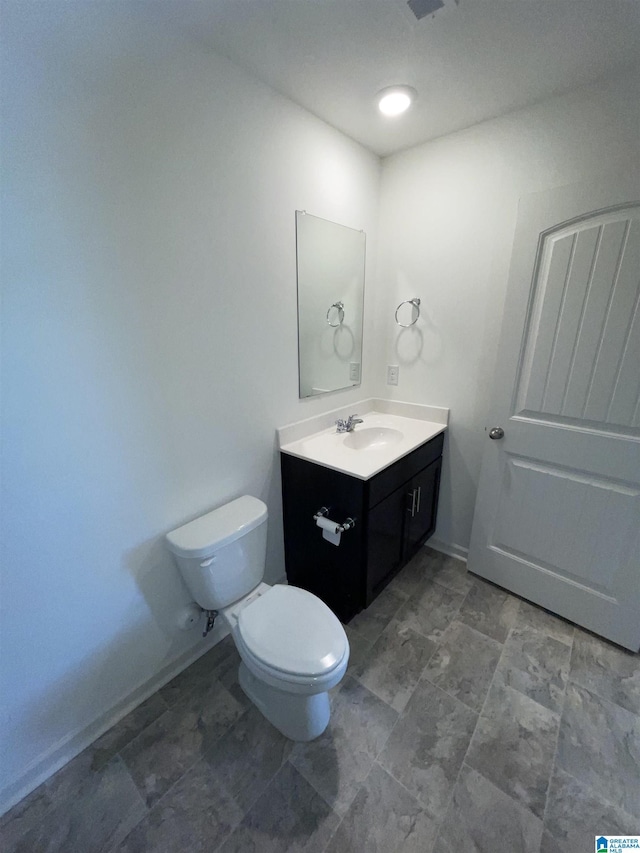 bathroom featuring vanity and toilet