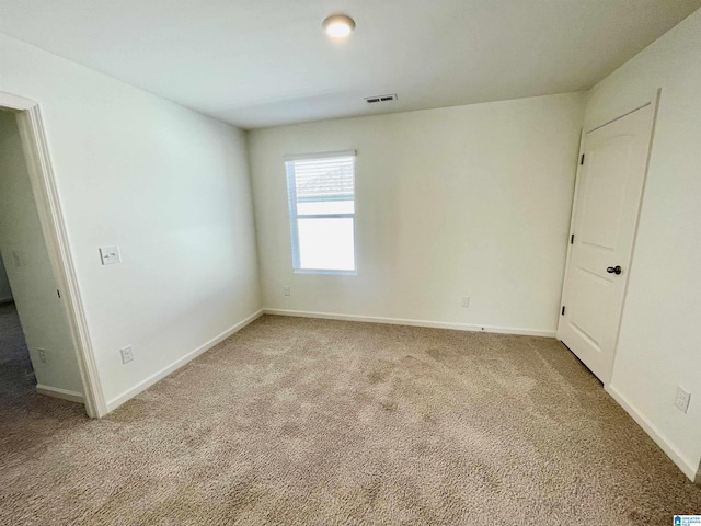 unfurnished room with light carpet