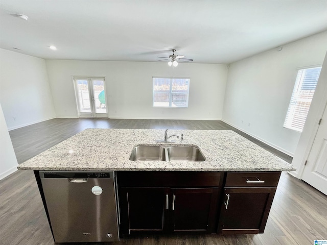 kitchen with wood-type flooring, dishwasher, sink, and a center island with sink