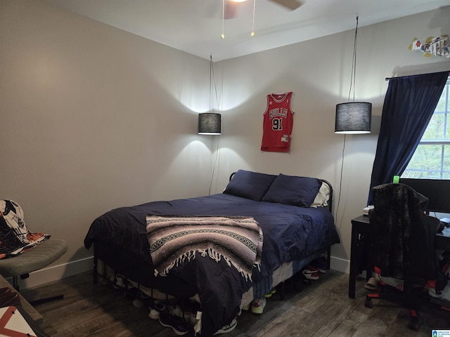 bedroom featuring ceiling fan, dark wood-type flooring, and baseboards