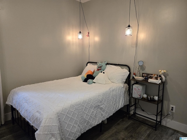 bedroom featuring dark wood-style flooring and baseboards