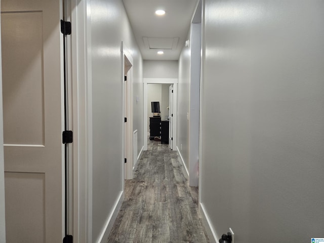 hallway featuring recessed lighting, wood finished floors, attic access, and baseboards