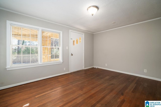 empty room with crown molding and dark wood-type flooring