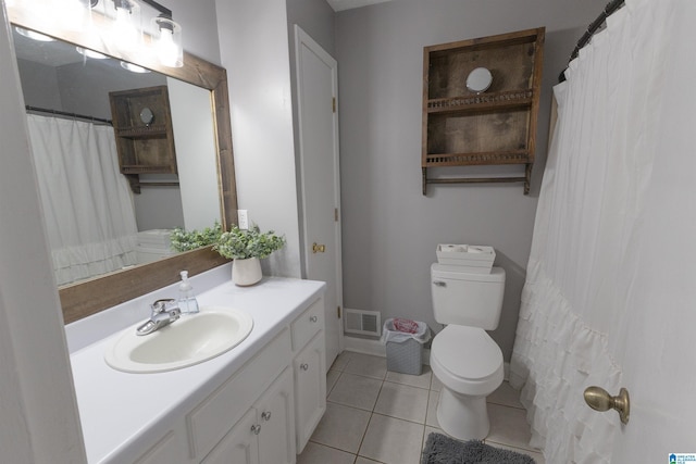 bathroom with vanity, tile patterned floors, and toilet