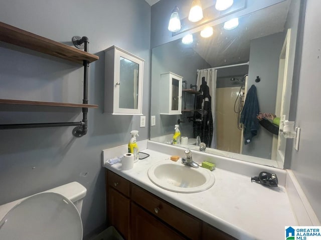 bathroom with vanity, curtained shower, and toilet