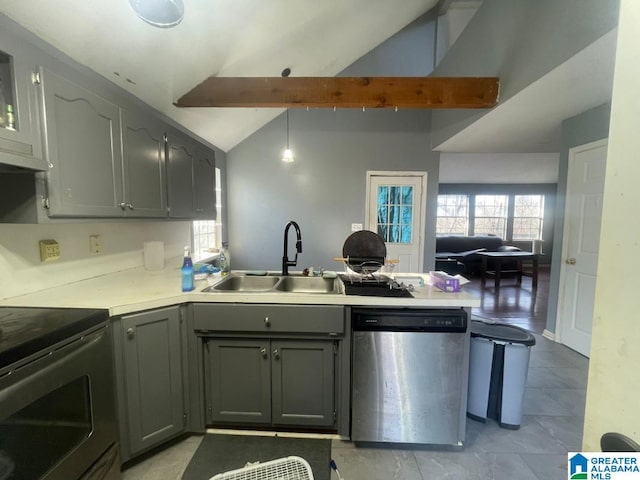 kitchen with sink, gray cabinetry, lofted ceiling with beams, appliances with stainless steel finishes, and kitchen peninsula