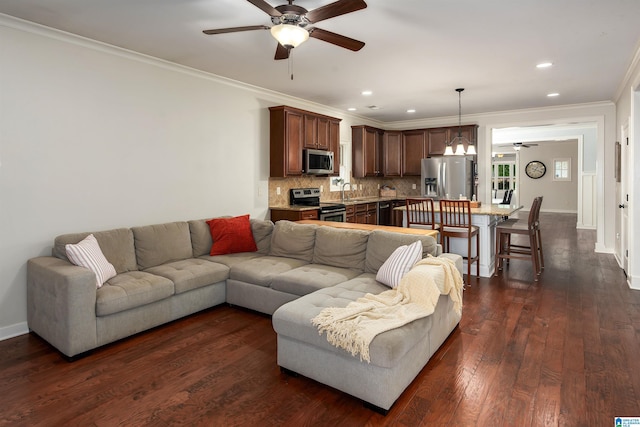 living room featuring crown molding, ceiling fan, and dark hardwood / wood-style floors