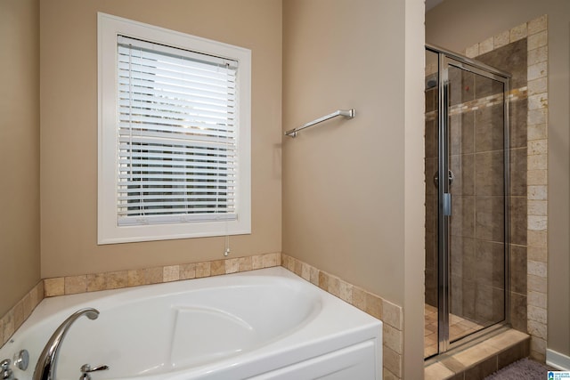 bathroom featuring shower with separate bathtub