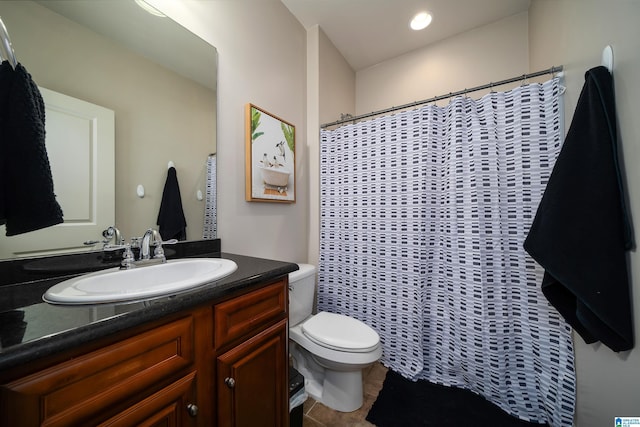 bathroom with vanity, tile patterned flooring, and toilet