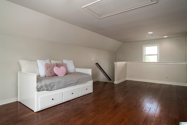 unfurnished bedroom featuring lofted ceiling and dark hardwood / wood-style flooring