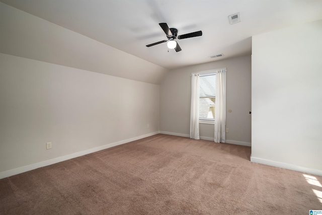 bonus room with vaulted ceiling, light carpet, and ceiling fan