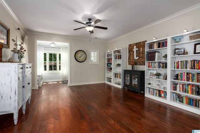 living area with ornamental molding, dark wood-type flooring, and ceiling fan