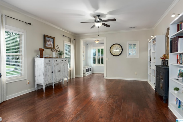 unfurnished living room featuring crown molding, ceiling fan, dark hardwood / wood-style floors, and a wealth of natural light