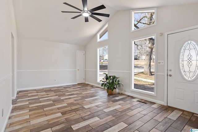 entrance foyer with ceiling fan and high vaulted ceiling