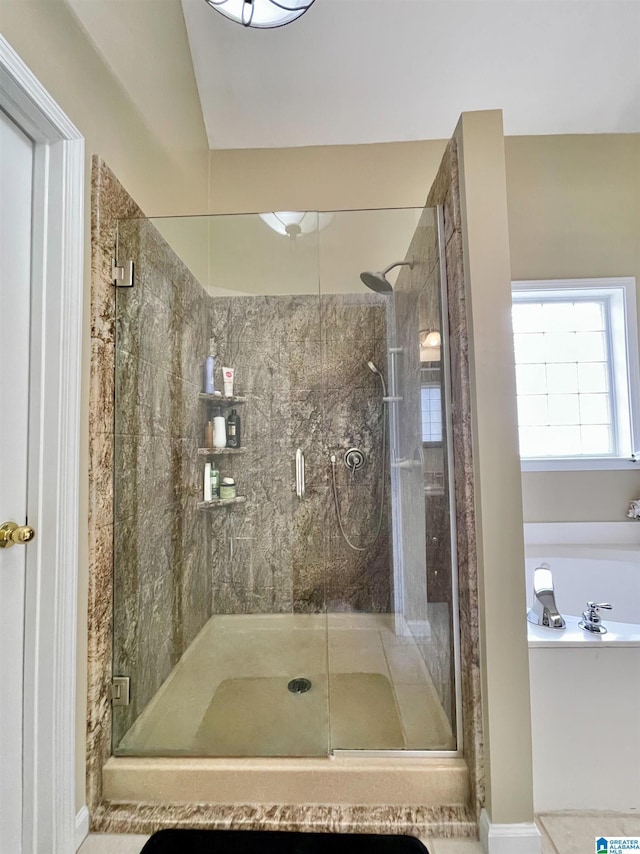 bathroom with a shower with shower door