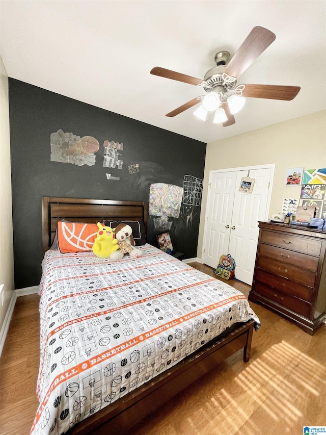 bedroom featuring light hardwood / wood-style flooring, a closet, and ceiling fan