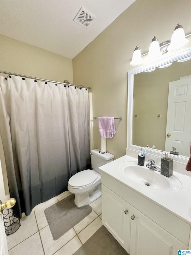 bathroom with vanity, toilet, and tile patterned flooring