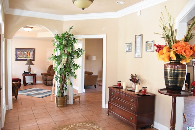 hallway featuring ornamental molding and light tile patterned floors