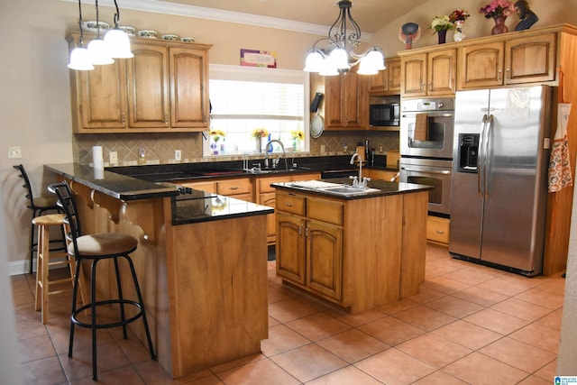 kitchen with sink, decorative light fixtures, kitchen peninsula, a kitchen island, and stainless steel appliances