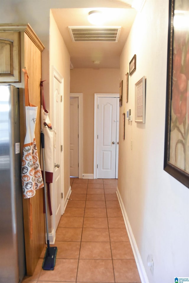 corridor with light tile patterned floors