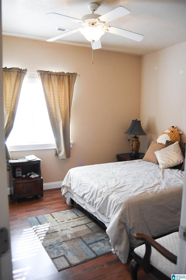 bedroom featuring dark wood-type flooring and ceiling fan