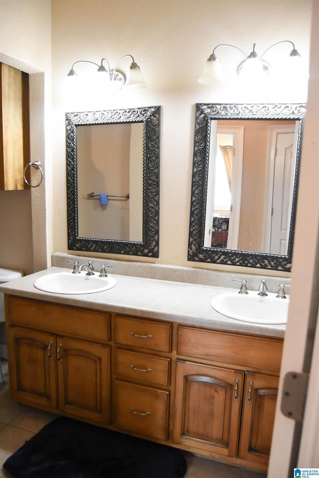 bathroom with tile patterned flooring, vanity, and toilet