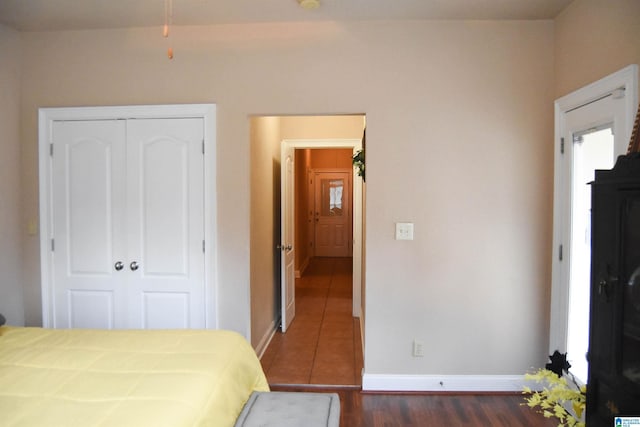 bedroom featuring dark hardwood / wood-style flooring and a closet